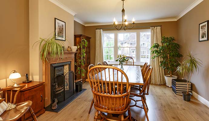 Dining room interior with a wooden table, chairs and decorative accents