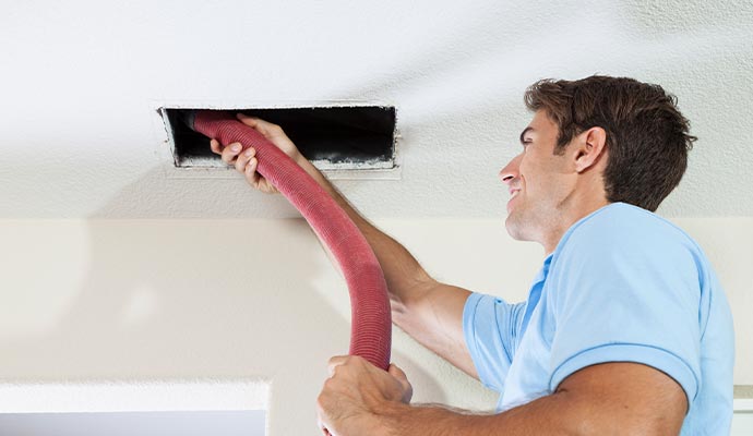 Professional worker cleaning duct system