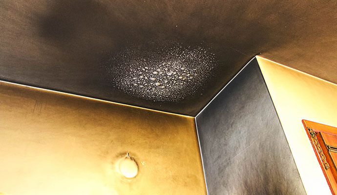 Ceiling and wall damaged due to smoke and soot