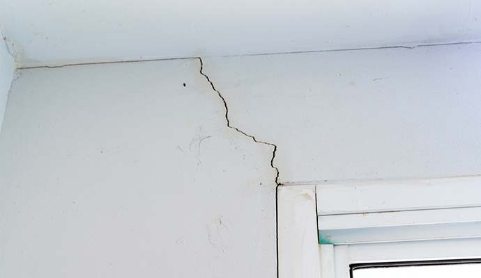 Interior wall showing visible cracks in the drywall surface.