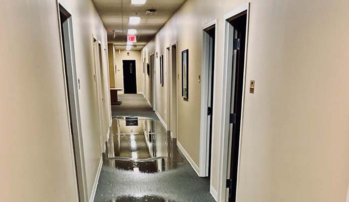 Indoor hallway with wet floor due to water leakage