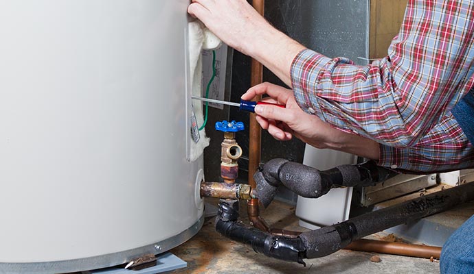 Professional hot water heater repairing service Skilled technician expertly repairing a hot water heater
