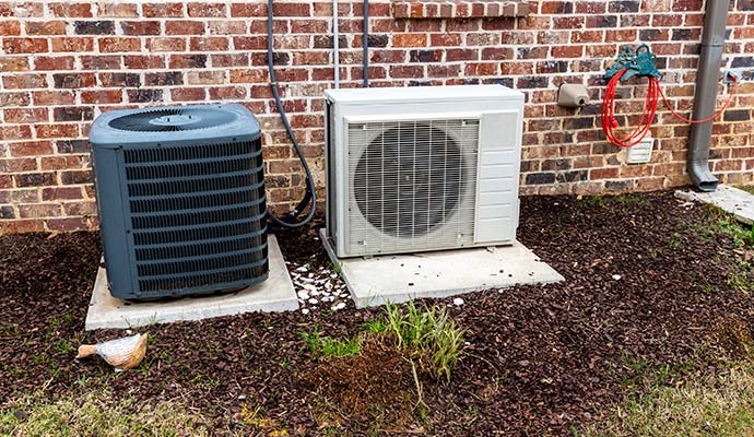 Exterior view of a residential HVAC outdoor unit placed on a concrete base.