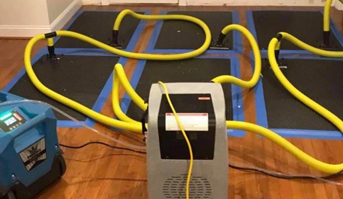 Water damage clean up service using equipment