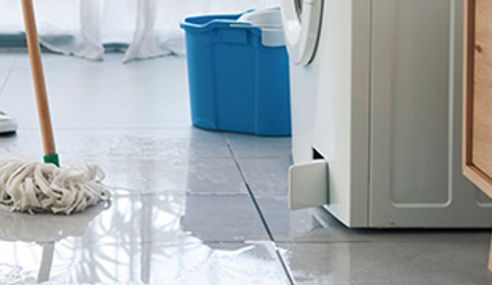 Water leaking from leaky washing machine